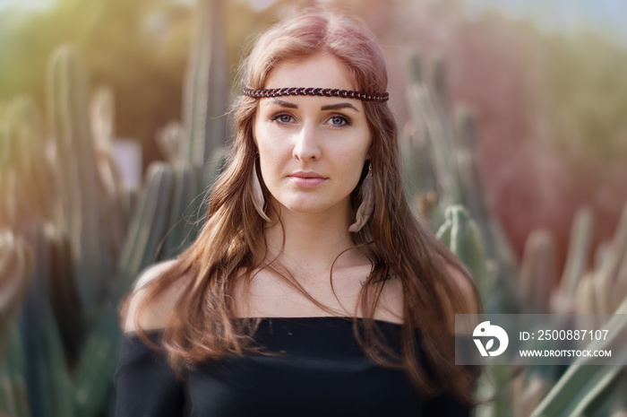 Portrait of a young hippie woman with long hair and blue eyes