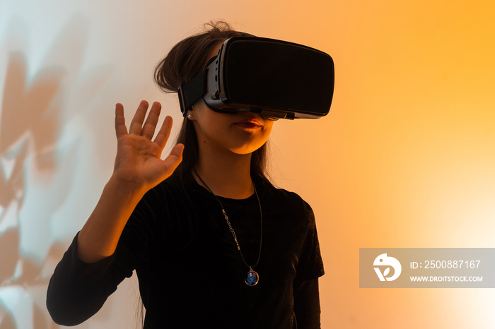 amazed teen girl wear vr glasses using technology for education in virtual reality, virtual world. Banner of child girl with virtual reality vr headset, studio portrait with copy space