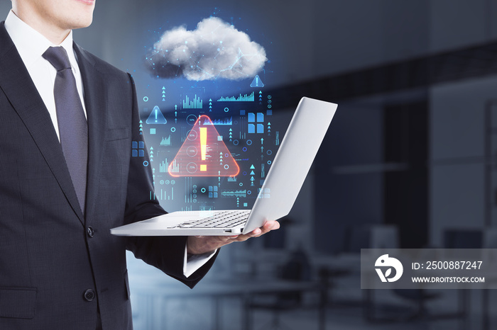 Close up of businessman hand holding laptop in blurry office interior with abstract hologram raining cloud. Data, information leak, security and theft concept. Double exposure.