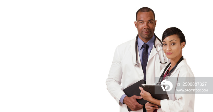 Two African American doctors posing for a portrait while holding their tablets on a white backdrop. Black medial experts standing in the hospital with their pads on a blank background