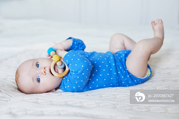 Baby girl playing with colorful toy