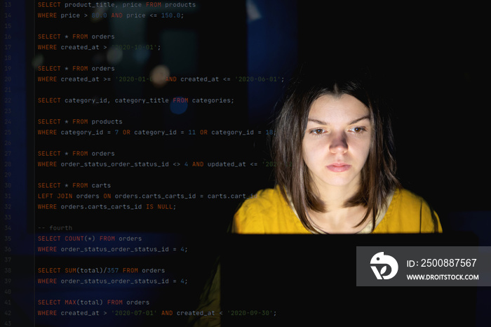 Girl works on a laptop at night, coding and creating project.