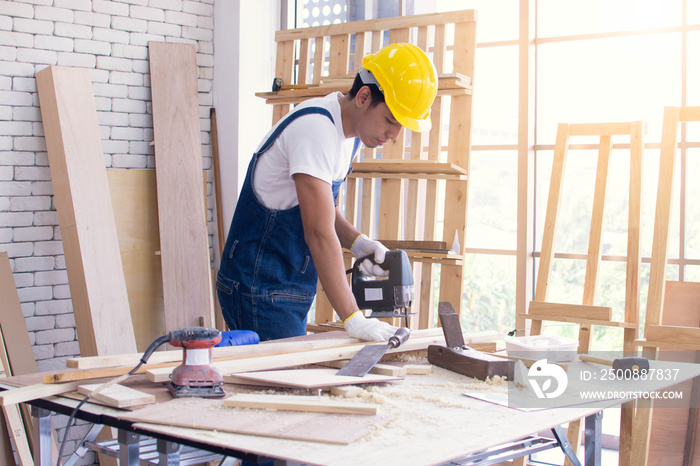 Portrait of an asian man wearing blue apron and standing in living room