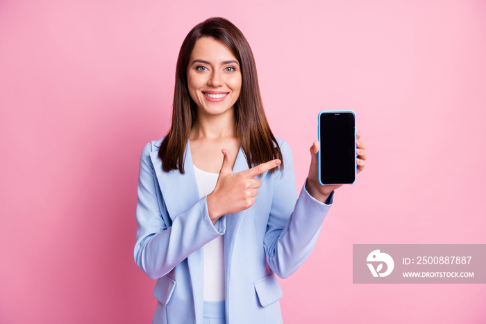 Photo of young beautiful girl happy smile point finger cellphone advert promo advice recommend isolated over pink color background