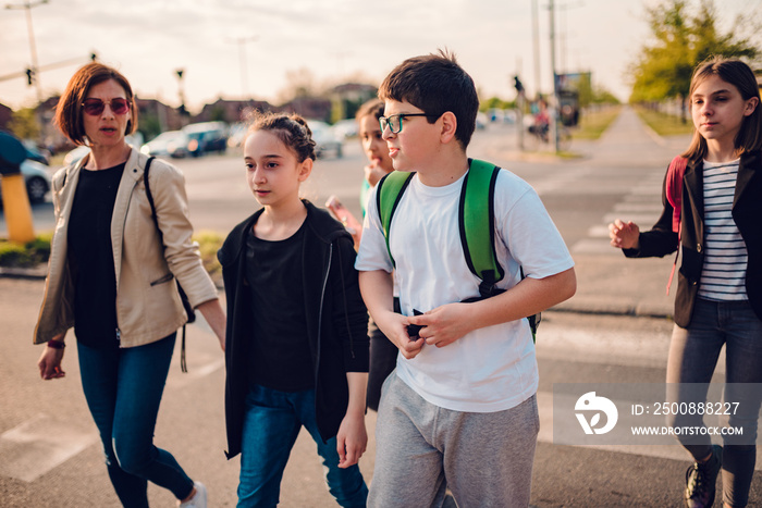 Group of school children crossing road