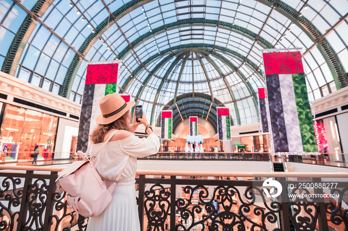 A young tourist walks through one of the largest shopping centers in Dubai - Emirates Mall