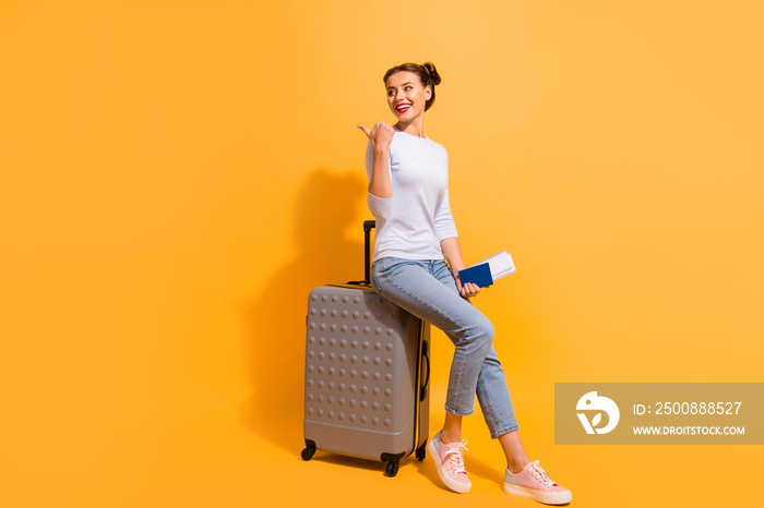 Full length side profile body size photo beautiful hairdo she her lady go abroad flight documents advising airport service wear casual jeans denim pullover sit big trolley isolated yellow background