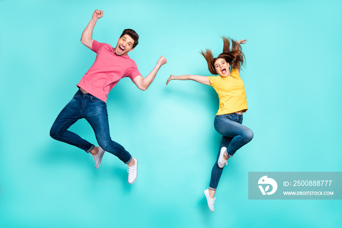 Full length body size view of nice attractive crazy funky cheerful carefree couple jumping in air having fun fooling rejoicing dancing isolated on bright vivid shine vibrant green turquoise background