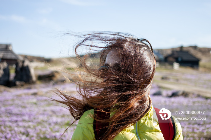 young beautiful woman walking outside windy day