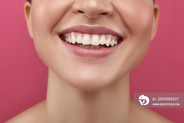 Joyful young woman demonstrating her white healthy teeth