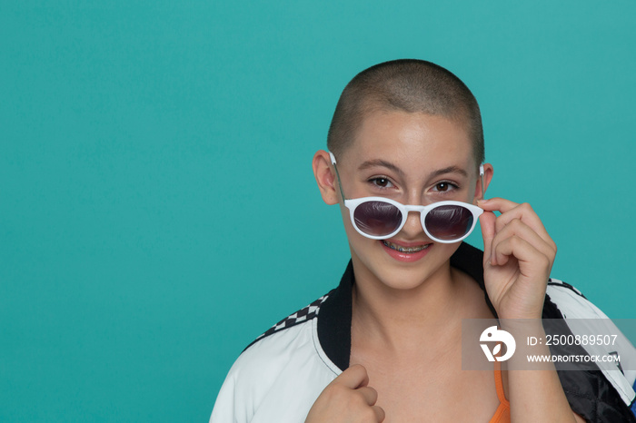 Studio portrait of stylish girl with sunglasses