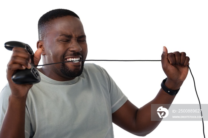 Frustrated man biting a wire of joystick