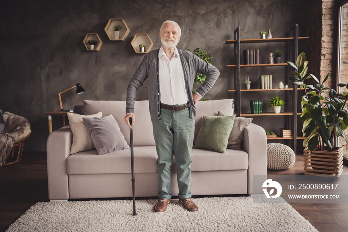 Full length photo of funny old man dressed white shirt standing with help walking cane indoors flat home house