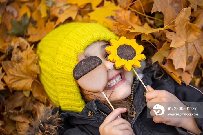 Bright autumn gingerbread in the hands of a child.