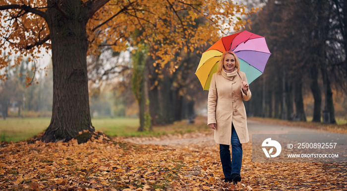 Senior woman in park in autumn