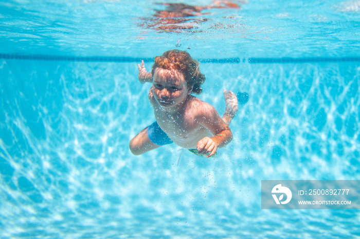 Child swimming in pool underwater. Child boy swim under water in pool.