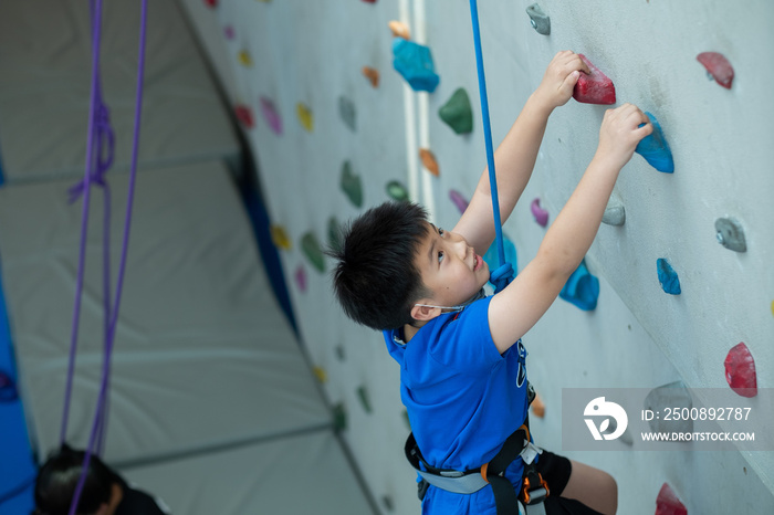 kid climbing a wall, children rock climbing