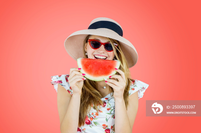 Caucasian woman eating watermelon on studio