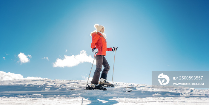 Woman enjoying her winter vacation on ski