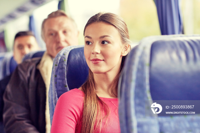 happy young woman sitting in travel bus or train