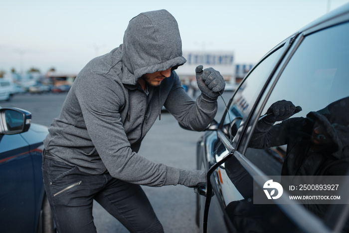 Car thief breaking door lock, criminal job