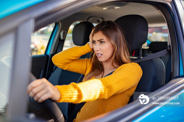 Nervous female driver sits at wheel, has worried expression as afraids to drive car by herself for first time. Frightened woman has car accident on road. People, driving, problems with transport