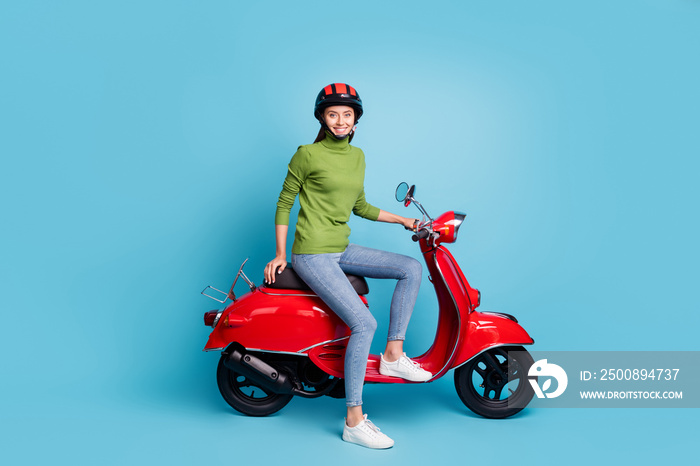 Full size profile portrait of positive adorable lady sit on moped toothy smile isolated on blue color background