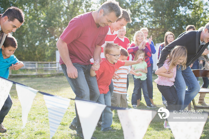 Family cheering on participants in 3 legged race