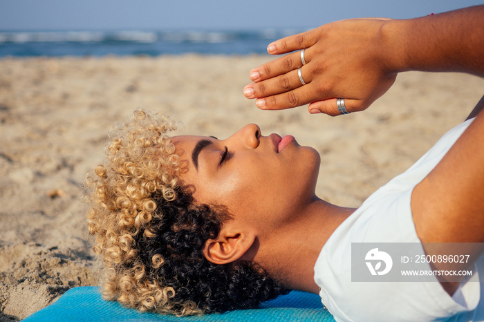 brazilian hispanic woman training yoga on the beach