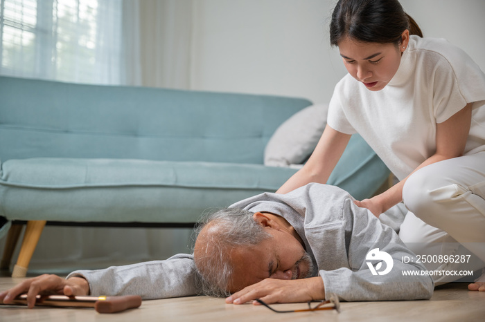 Asia young woman halping her father after falling down on floor, elderly old man with walking stick fall on ground and daughter camp to help at home in living room, family health care