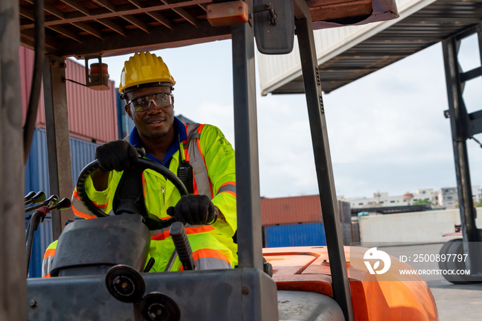 African american man driving forklift in shipyard . Logistics supply chain management and international goods export concept .