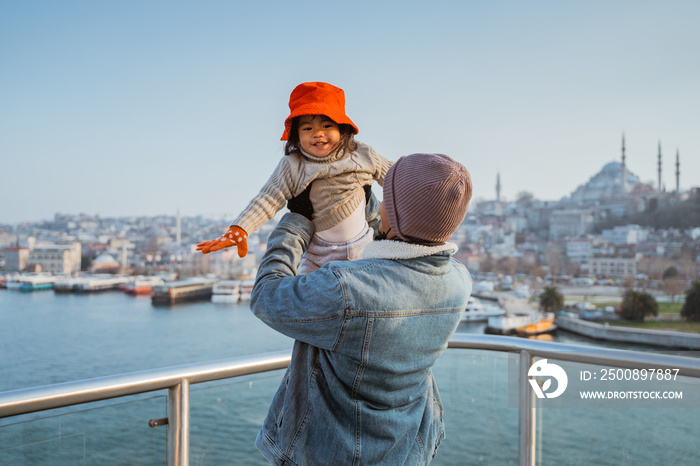 father and daughter travel to turkey. portrait of dad and kid enjoying the view of beautiful istanbul turkey from the bridge