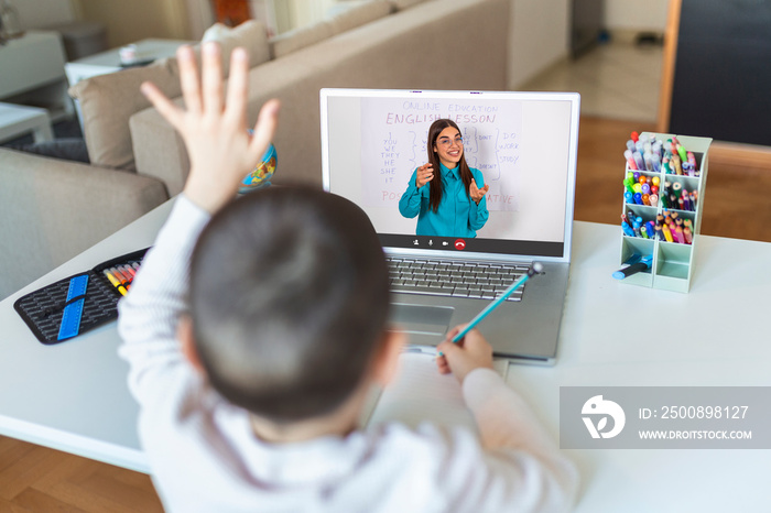 Homeschool little young boy student learning virtual internet online class from school teacher by remote meeting due to covid pandemic. Female teaching english by using whiteboard.