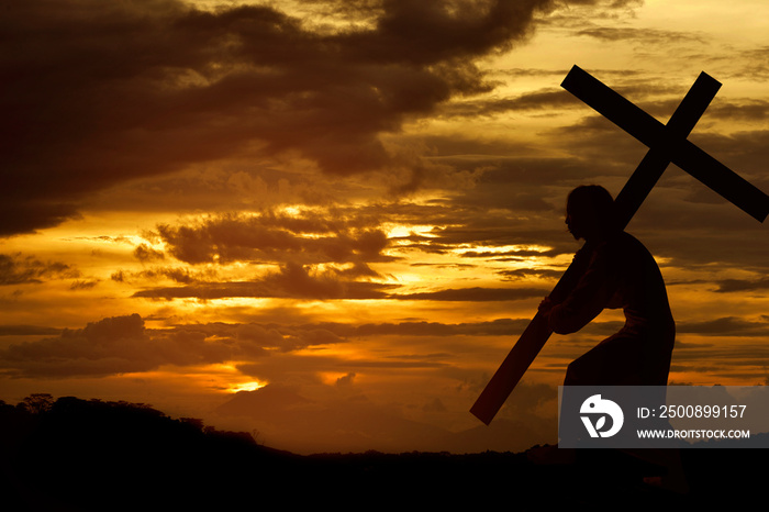 Silhouette of Jesus christ carrying cross