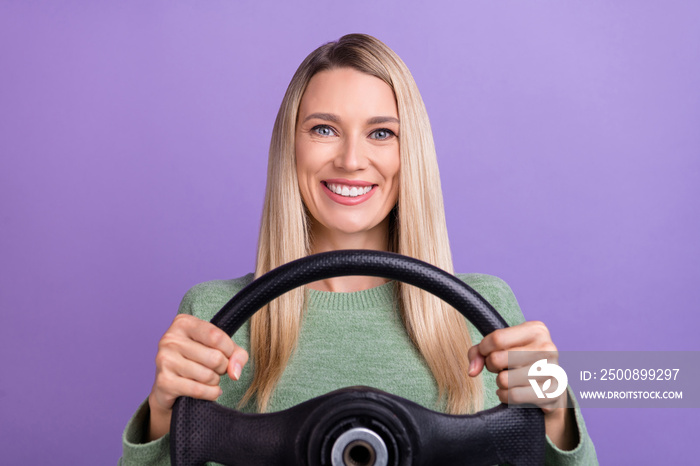 Photo of cheerful mature woman ride car driver steering-wheel vacation isolated over purple color background