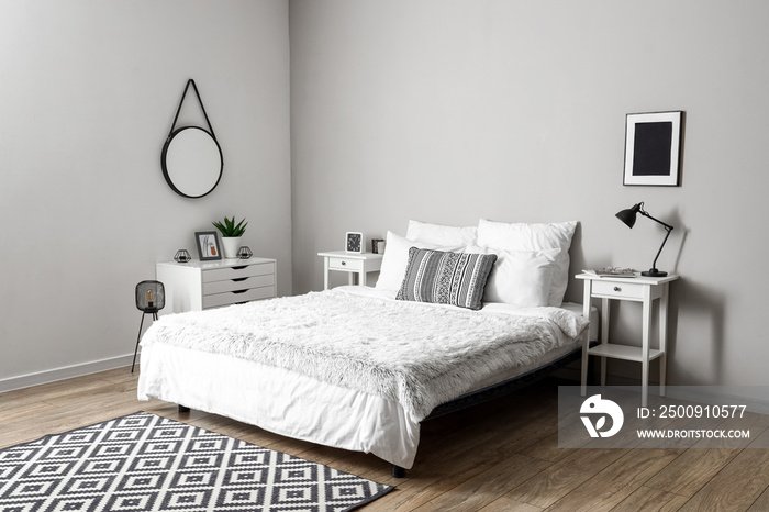 Interior of light bedroom with tables