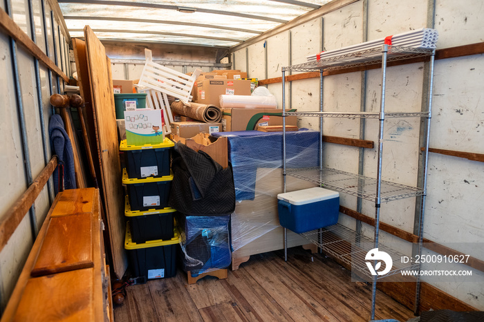 Belongings from a house being loaded into a moving van