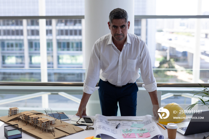 Mature man looking at camera on desk