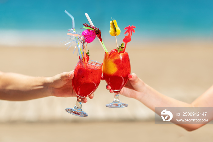 man and woman hands holding cocktail glasses. Summer concept.