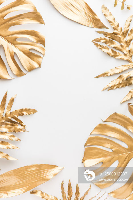Flat lay of golden tropical leaf design elements. Decoration elements for invitation, wedding cards,