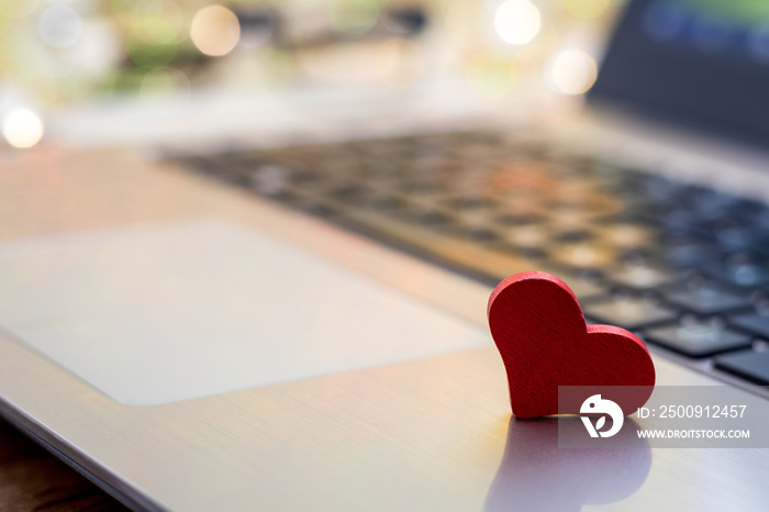 Online Dating concept with laptop red heart shape