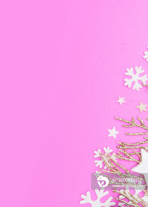 Christmas pink background with golden twigs, stars and snowflakes. Copy space