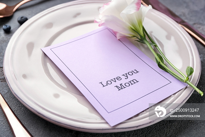 Elegant table layout for dinner with flower and greeting card