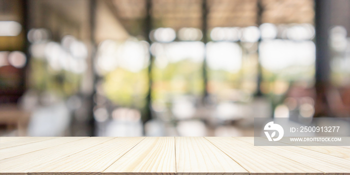 Empty wood table top with cafe restaurant interior blur background