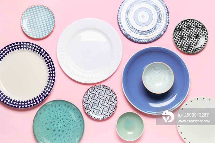 Composition with stylish ceramic plates on pink background