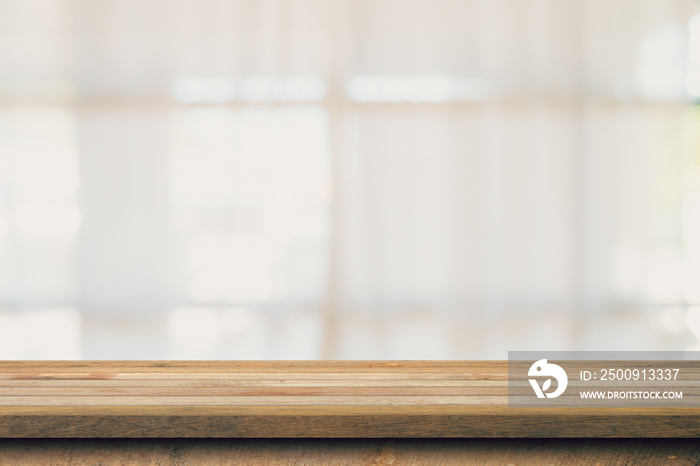 Wooden table top with blurred people in coffee shop and cafe background for display montage, copy sp