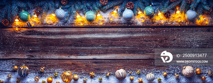 Cozy copy space background with spruce branches and Christmas tree ornaments on barn wood