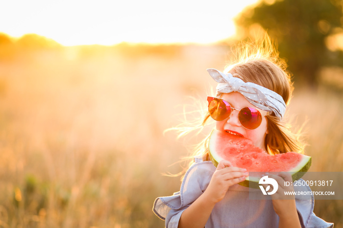 Adorable girl with watermelon slice