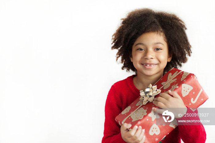 Happy adorable african american child girl  with christmas gift in hands isolated on white backgroun