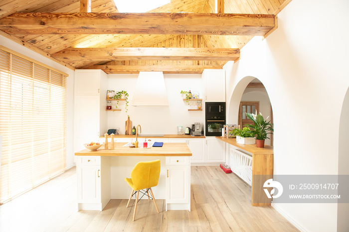 White kitchen with large center island.